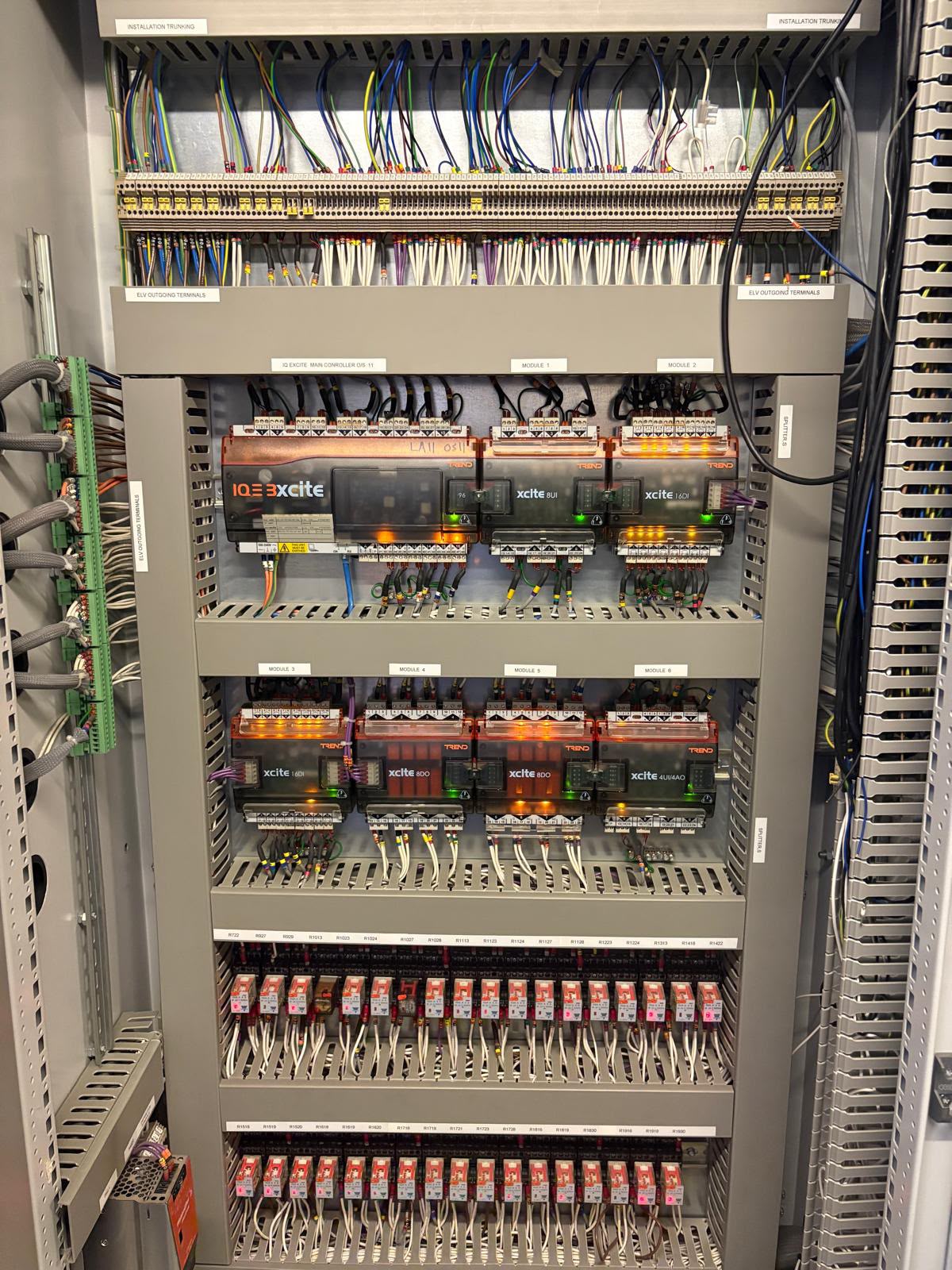 Original Trend IQ3 Xcite BMS control panel with legacy controller modules and dense field wiring before upgrade
