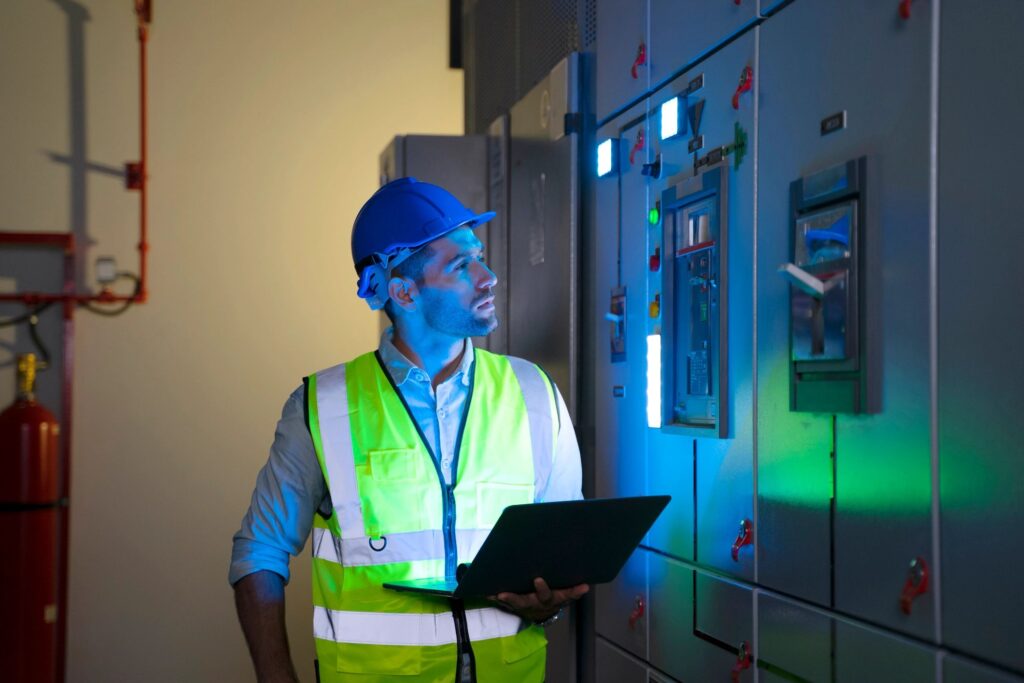 Facilities engineers working in a plant room on building services equipment